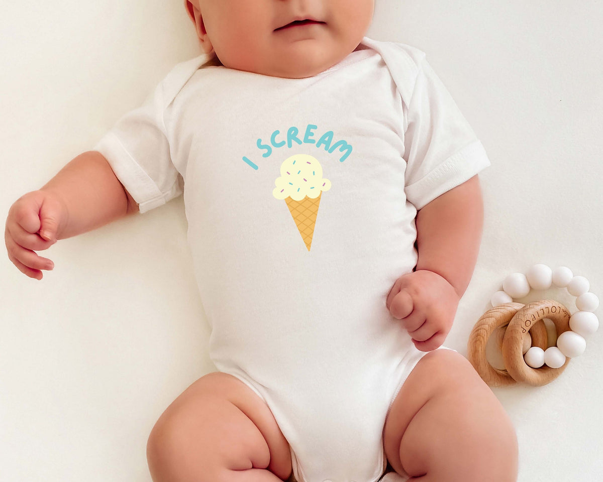 Baby wearing a white cotton onesie with an ice cream cone graphic and the playful 'I Scream' text.