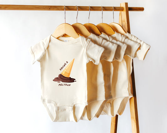 A short sleeve cotton baby bodysuit with a graphic of a melting ice cream cone and the text "having a meltdown"