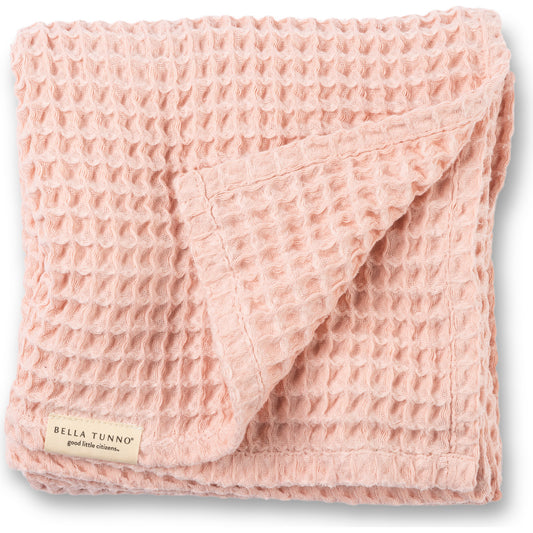 Pink waffle texture baby blanket with a Bella Tunno visible brand label 