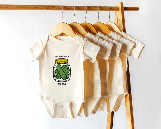 A short sleeve cotton baby onesie with a pickle jar graphic and the text "i'm kind of a big dill"