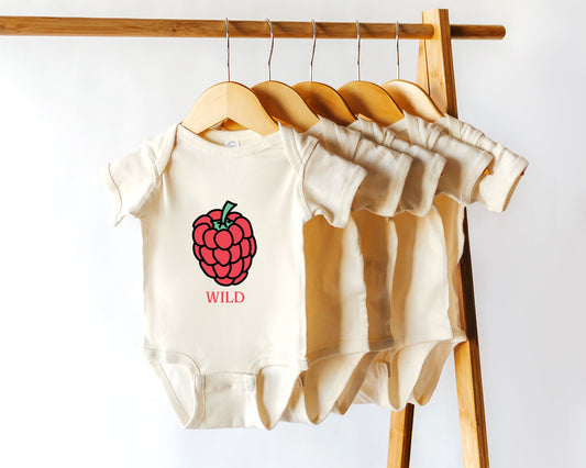 A short sleeve cotton baby onesie with a raspberry graphic on it and the text "wild"